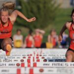 Two female athletes, compete in the hurdle discipline