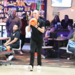 Student prepares to bowl with an orange ball