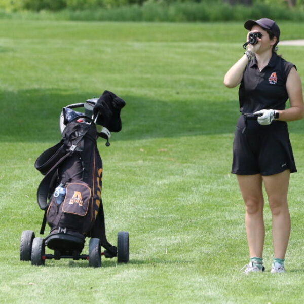 Student playing golf
