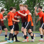 Ethan Sigurdsson celebrates with teammates after scoring the opening goal against No. 8 Des Moines in Wednesday's substate final (Photo: William Jenks)