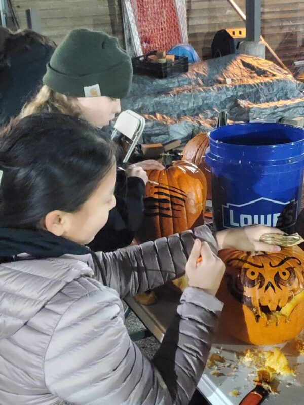 students carving pumpkins