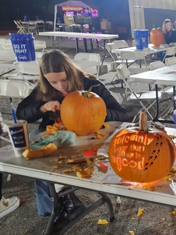 students carving pumpkins