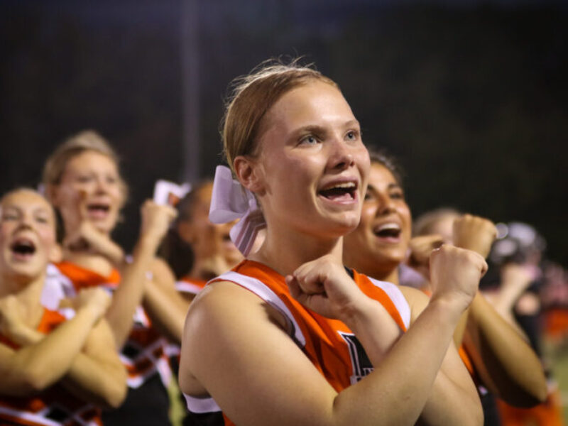 Cheerleader cheering during the football game