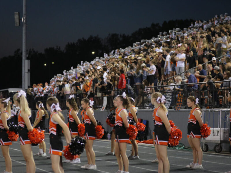 Cheerleaders and the student section at a football game