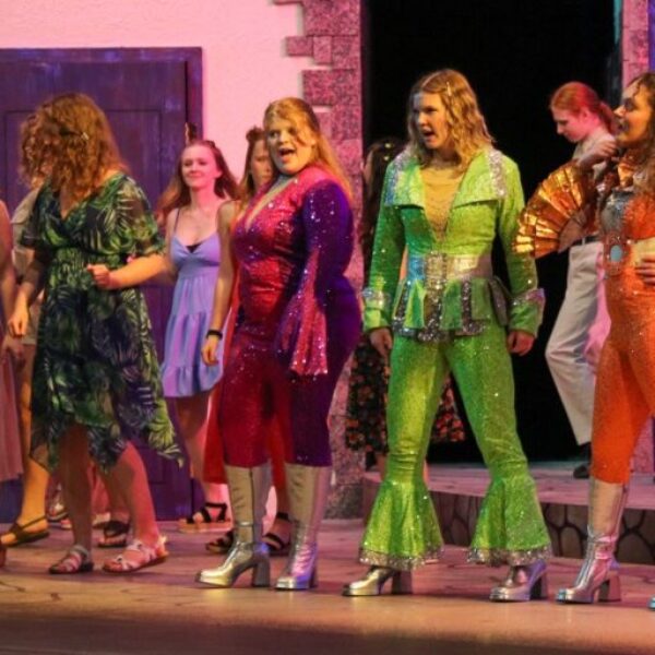 Students singing and dance in the Mamma Mia musical