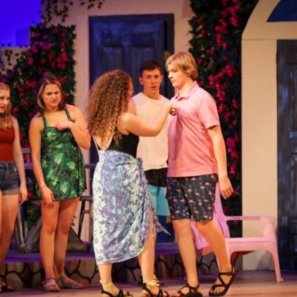 Students singing and dancing in the Mamma Mia musical