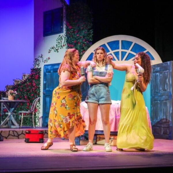 Students singing and dancing in the Mamma Mia musical