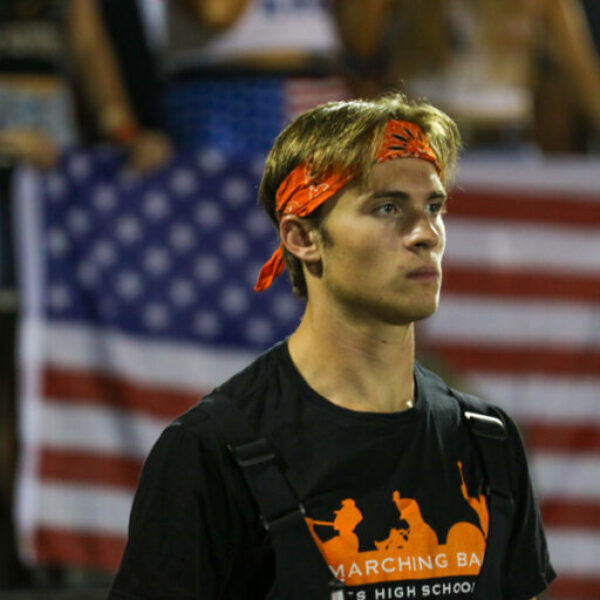 Member of the drumline pauses during the game