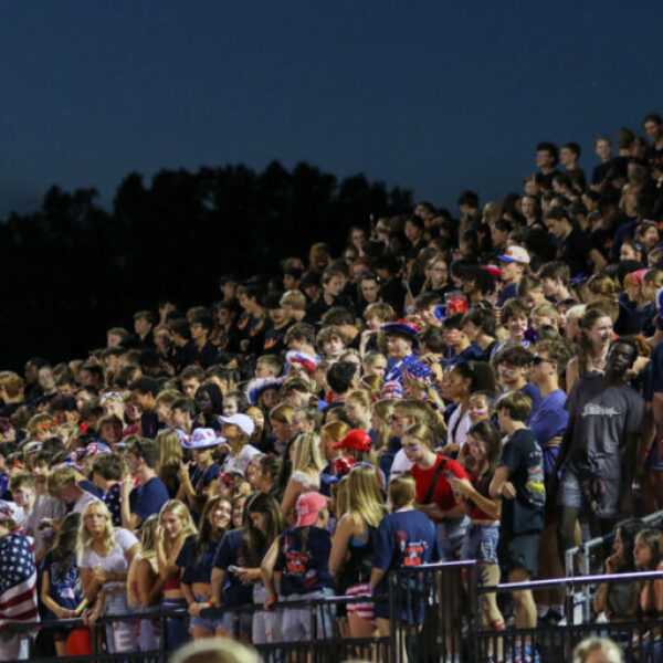 The crowd cheering during the football game.