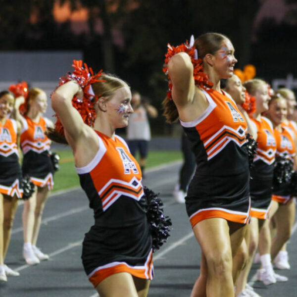 Cheerleaders cheering during the football game