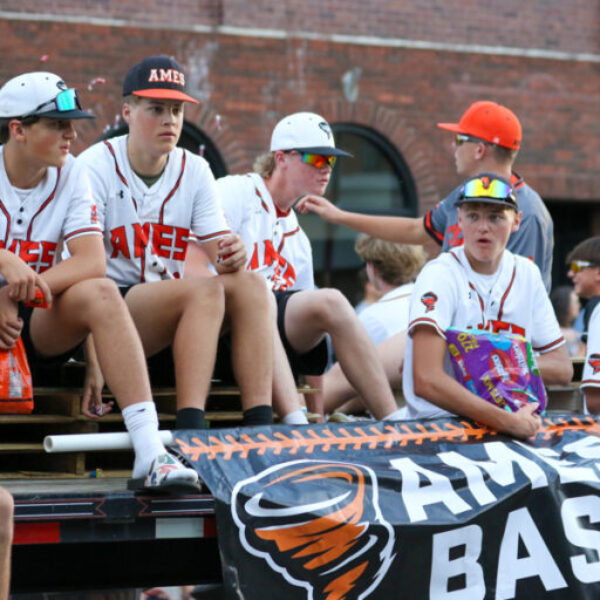 Ames High baseball players throw candy in the homecoming parade