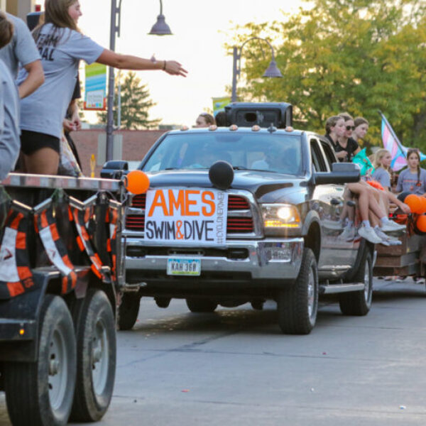 Truck with swim and dive sign on the front in the parade