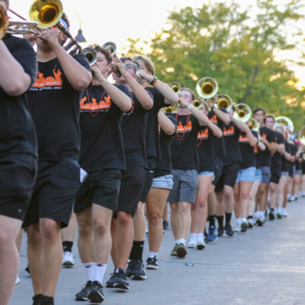 students marching for the band in the parade