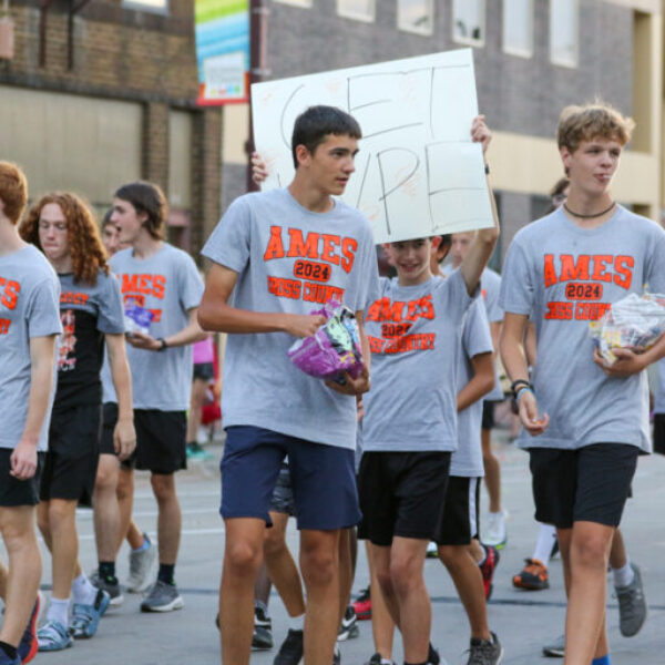 boys cross country throwing candy in the parade