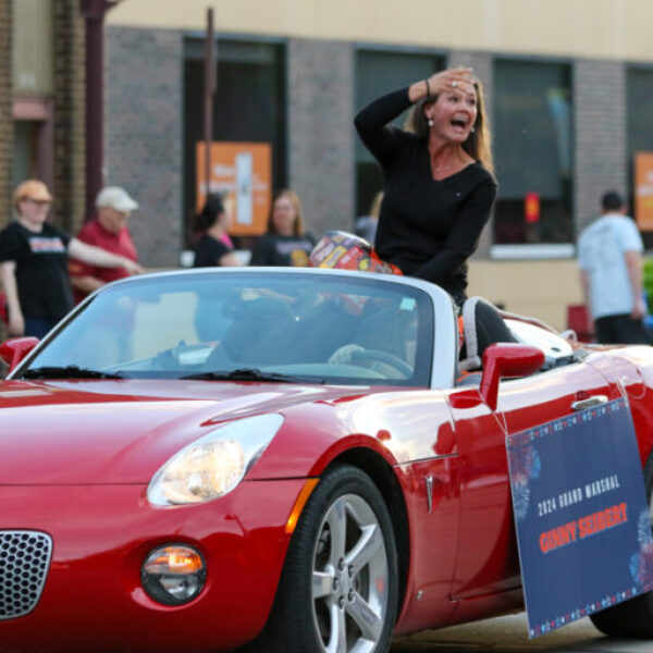 teacher throws candy in the parade