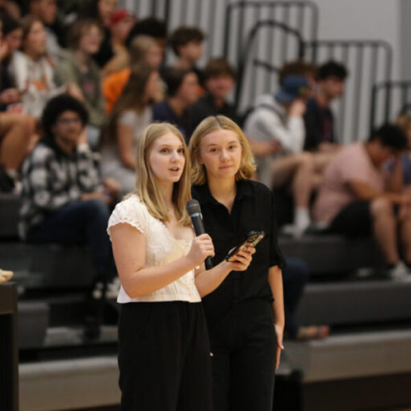 Homecoming pep rally organizers making an announcement