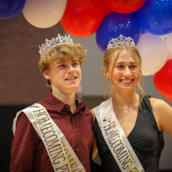 Homecoming prince and princess smile for pictures