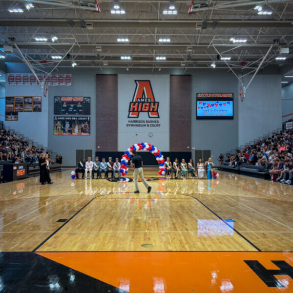 Ames High gymnasium during the Homecoming pep rally with bleachers full of students