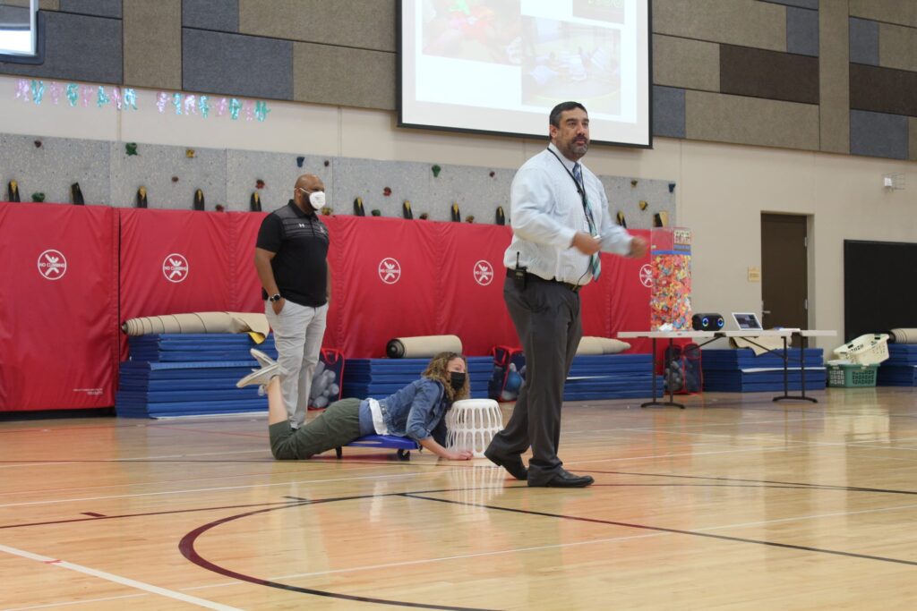 Fellows staff getting ready to play a game during an assembly