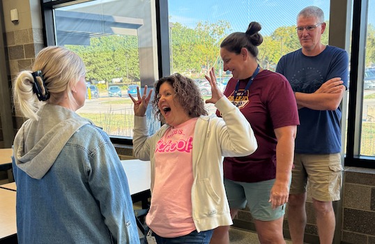 Staff practicing what different emotions might look like during Professional Development